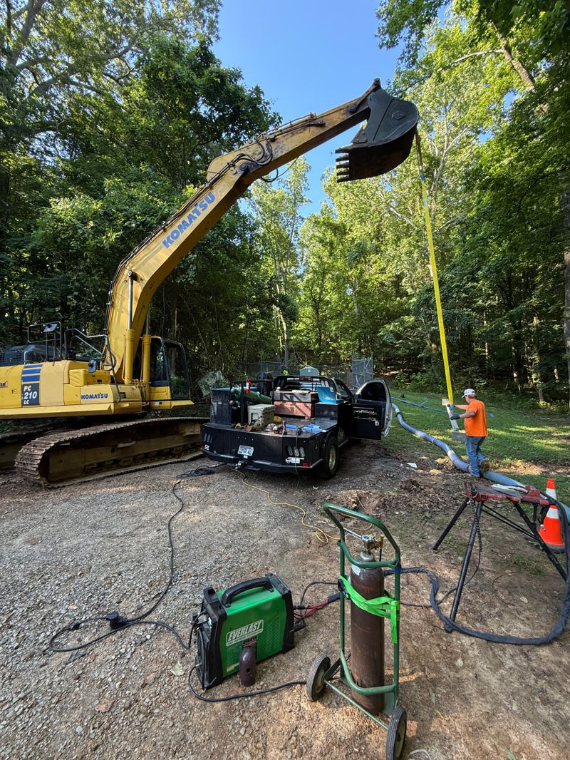 Mobile welding truck and welder set up on site for a boom and bucket repair on a Komatsu excavator